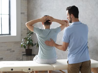 medium-shot-man-helping-patient-physiotherapy